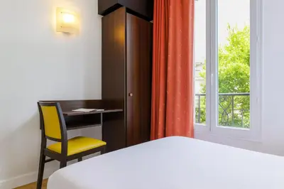 Un ou plusieurs lits dans un hébergement de l'établissement Hotel Arc Paris Porte d'Orléans