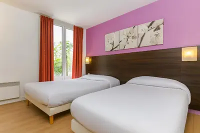 Un ou plusieurs lits dans un hébergement de l'établissement Hotel Arc Paris Porte d'Orléans