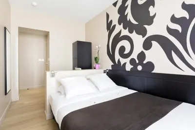 Un ou plusieurs lits dans un hébergement de l'établissement Hotel Bastille Secret