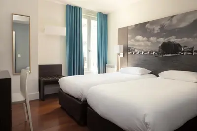 Un ou plusieurs lits dans un hébergement de l'établissement Hotel Victoria