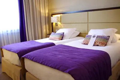 Un ou plusieurs lits dans un hébergement de l'établissement Hôtel Paris Neuilly