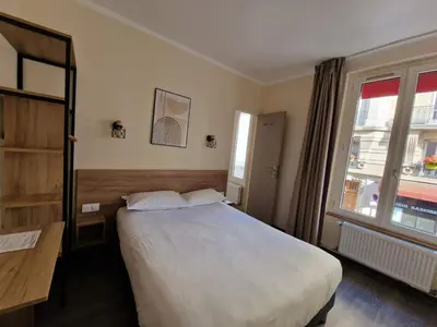 Un ou plusieurs lits dans un hébergement de l'établissement Hôtel D'Anjou