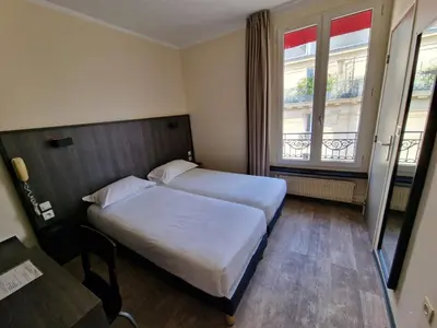 Un ou plusieurs lits dans un hébergement de l'établissement Hôtel D'Anjou