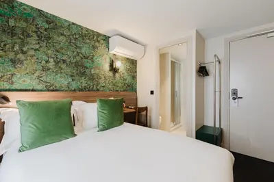 Un ou plusieurs lits dans un hébergement de l'établissement Hotel Prince Albert Opéra