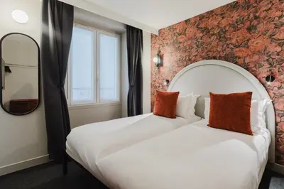 Un ou plusieurs lits dans un hébergement de l'établissement Hotel Prince Albert Opéra