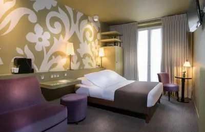 Un ou plusieurs lits dans un hébergement de l'établissement Gardette Park Hotel