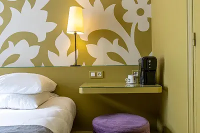Un ou plusieurs lits dans un hébergement de l'établissement Gardette Park Hotel