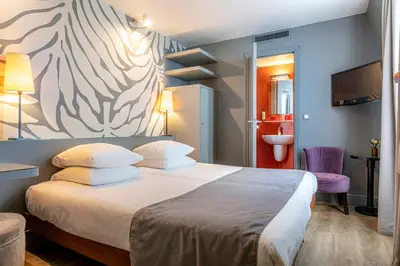 Un ou plusieurs lits dans un hébergement de l'établissement Gardette Park Hotel