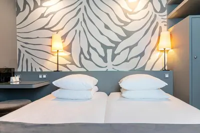 Un ou plusieurs lits dans un hébergement de l'établissement Gardette Park Hotel