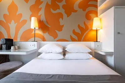 Un ou plusieurs lits dans un hébergement de l'établissement Gardette Park Hotel
