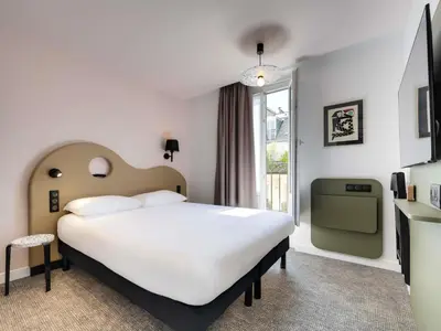Un ou plusieurs lits dans un hébergement de l'établissement ibis Styles Paris Cadet Lafayette
