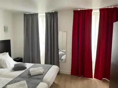 Un ou plusieurs lits dans un hébergement de l'établissement Hôtel de Bordeaux