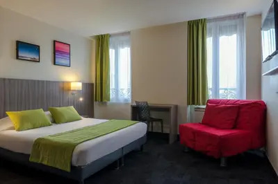 Un ou plusieurs lits dans un hébergement de l'établissement Reims Hotel