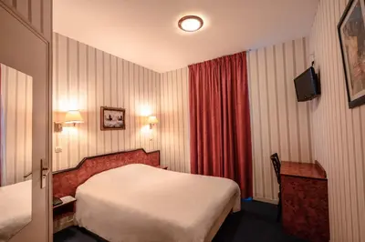 Un ou plusieurs lits dans un hébergement de l'établissement Hôtel Neptune Place d'Italie
