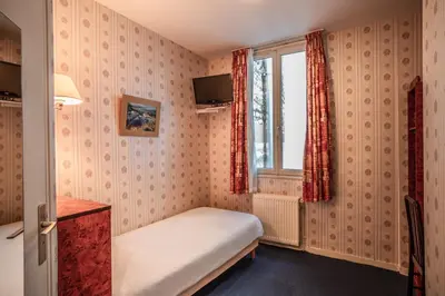 Un ou plusieurs lits dans un hébergement de l'établissement Hôtel Neptune Place d'Italie