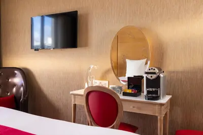 Télévision ou salle de divertissement dans l'établissement Hotel Muguet