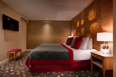 Un ou plusieurs lits dans un hébergement de l'établissement Hotel Muguet
