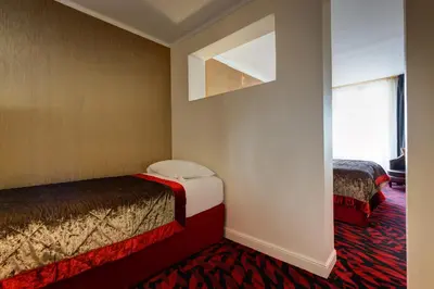 Un ou plusieurs lits dans un hébergement de l'établissement Hotel Muguet