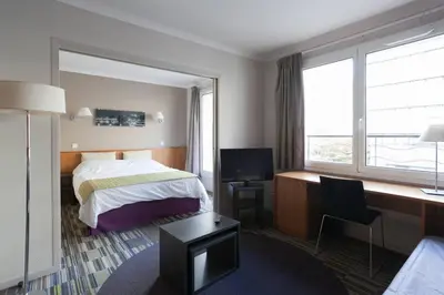 Un ou plusieurs lits dans un hébergement de l'établissement Aparthotel Paris 15 Porte de Versailles