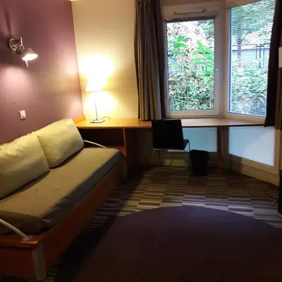 Un ou plusieurs lits dans un hébergement de l'établissement Aparthotel Paris 15 Porte de Versailles
