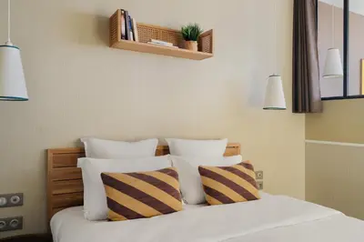 Un ou plusieurs lits dans un hébergement de l'établissement Edgar Suites Expo Paris Porte de Versailles