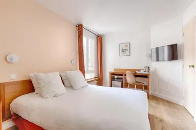 Un ou plusieurs lits dans un hébergement de l'établissement Hôtel Du Leman