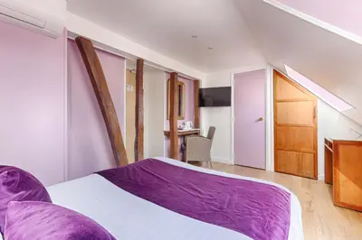 Un ou plusieurs lits dans un hébergement de l'établissement Hôtel Du Leman