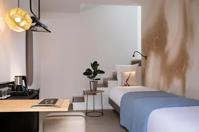 Un ou plusieurs lits dans un hébergement de l'établissement Hôtel Les Deux Girafes