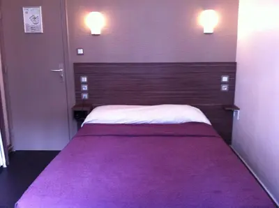 Un ou plusieurs lits dans un hébergement de l'établissement Grand Hôtel Magenta