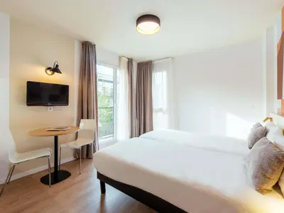 Un ou plusieurs lits dans un hébergement de l'établissement Aparthotel Adagio Access Paris Asnières