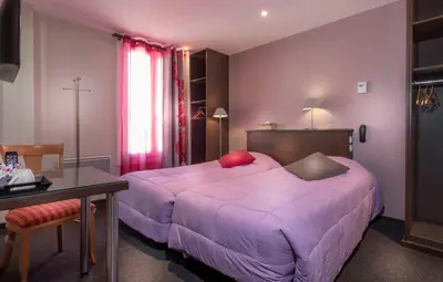 Un ou plusieurs lits dans un hébergement de l'établissement Hôtel Montsouris Orléans