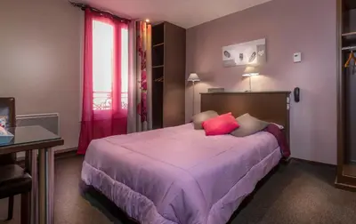Un ou plusieurs lits dans un hébergement de l'établissement Hôtel Montsouris Orléans