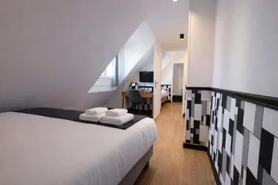 Un ou plusieurs lits dans un hébergement de l'établissement Hôtel Tilde