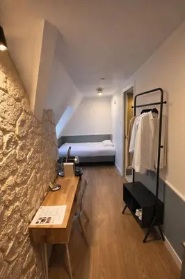 Un ou plusieurs lits dans un hébergement de l'établissement Hôtel Tilde