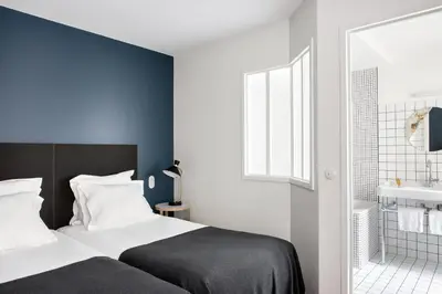 Un ou plusieurs lits dans un hébergement de l'établissement New Hotel Le Voltaire