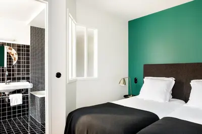 Un ou plusieurs lits dans un hébergement de l'établissement New Hotel Le Voltaire