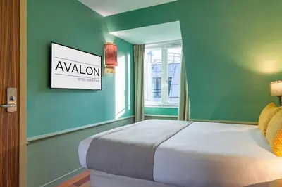 Un ou plusieurs lits dans un hébergement de l'établissement Appart Hotel Avalon