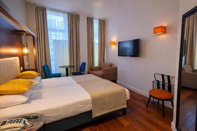 Un ou plusieurs lits dans un hébergement de l'établissement Appart Hotel Avalon