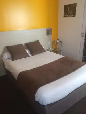 Un ou plusieurs lits dans un hébergement de l'établissement Hôtel de Paris La Défense