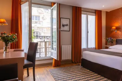 Un ou plusieurs lits dans un hébergement de l'établissement Hôtel Volney Opéra