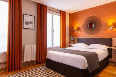 Un ou plusieurs lits dans un hébergement de l'établissement Hôtel Volney Opéra