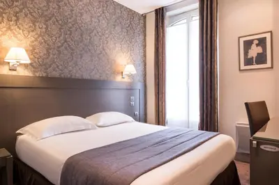 Un ou plusieurs lits dans un hébergement de l'établissement Hôtel Volney Opéra