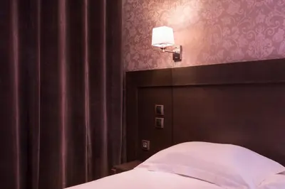 Un ou plusieurs lits dans un hébergement de l'établissement Hôtel Volney Opéra