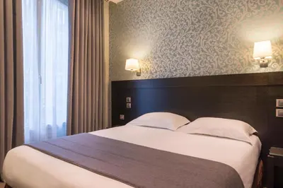 Un ou plusieurs lits dans un hébergement de l'établissement Hôtel Volney Opéra