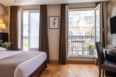 Un ou plusieurs lits dans un hébergement de l'établissement Hôtel Volney Opéra