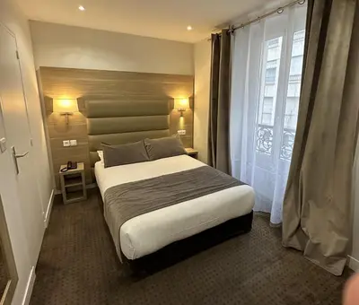 Un ou plusieurs lits dans un hébergement de l'établissement Hotel Agenor