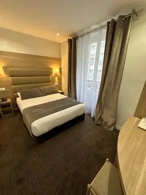 Un ou plusieurs lits dans un hébergement de l'établissement Hotel Agenor