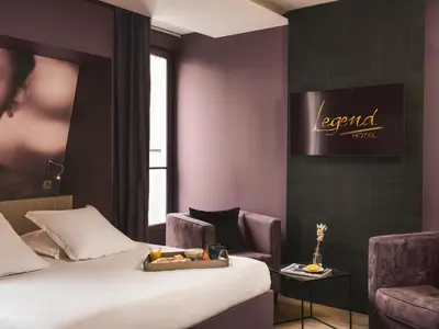 Un ou plusieurs lits dans un hébergement de l'établissement Legend Hôtel Paris