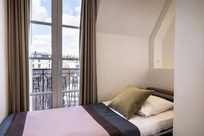 Un ou plusieurs lits dans un hébergement de l'établissement Hôtel Saint Pierre