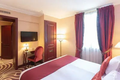 Un ou plusieurs lits dans un hébergement de l'établissement Hotel Du Beaumont